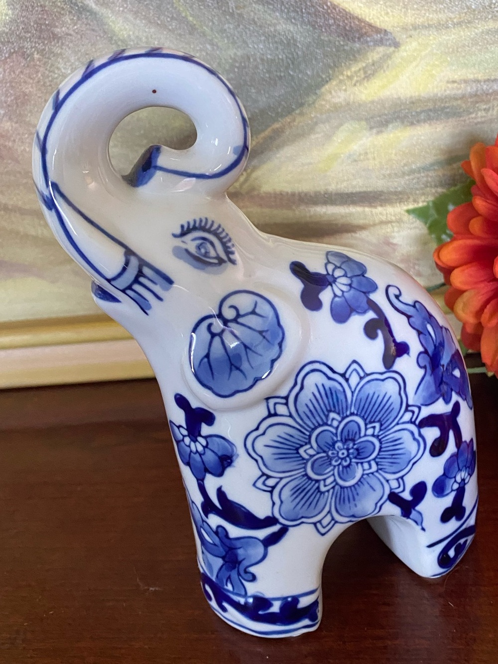 Vintage BluebWhite Chinoiserie ceramic elephant figurine with floral patterns.